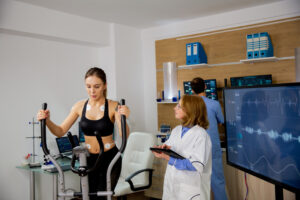 female athlete doing physical effort stepper doctor follows her sports laboratory 1